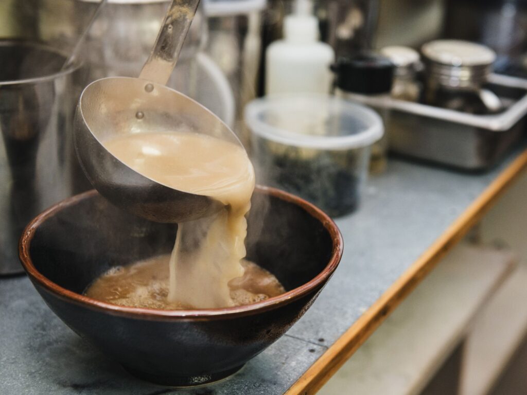 broth being poured into a both of ramen high res stock photography 695745168 1564414887