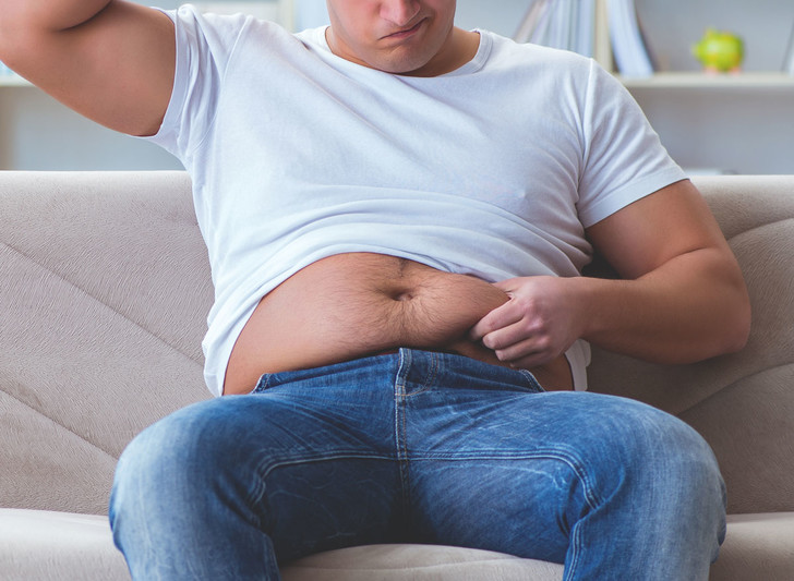 287336 man upset over belly fat